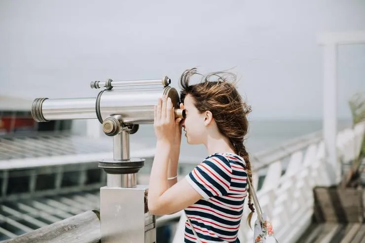 woman spying with a telescope